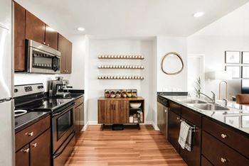 a large kitchen with a stove and a sink